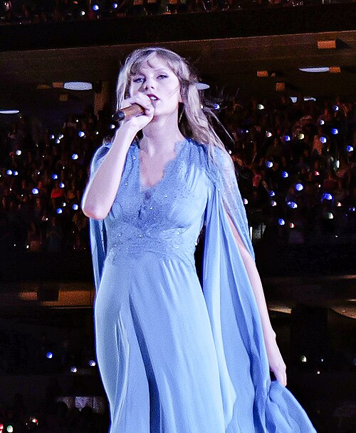 Taylor Swift performing during the Eras Tour on 9 August 2023, with a microphone near her mouth